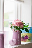 Pale pink hydrangeas in pale lilac jug on windowsill
