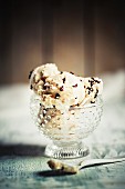 Vanilla ice cream with chocolate sprinkles in a glass bowl