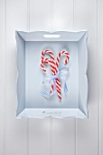Candy canes tied with a ribbon on a tray