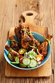 Spicy roast chicken legs with a vegetables salad