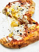 A pizza topped with egg and capers