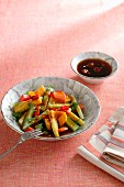 A fruit and vegetable salad with spicy chilli sauce