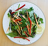Mixed leaf salad with vegetable strips and a mustard dressing