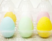 Pastel coloured Easter eggs in a plastic container