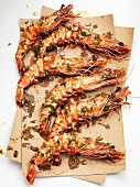 King prawns with herbs on brown paper