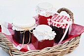 Damson jam and medlar jelly in a basket as a Christmas gift