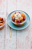 A dessert with apricots, raspberries and cinnamon cream