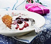 Rice pudding with cherry sauce and nut brittle