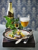 Soused herring on bread served with Aquavit and beer (Scandinavia)