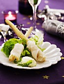 Halibut rolls on a bed of lettuce with cream cheese