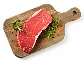 A raw rump steak on a chopping board