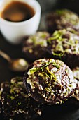 Chocolate muffins decorated with icing sugar and lime zest and served with an espresso
