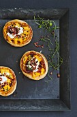 Puff pastry tartlets topped with bacon, ricotta and macaroni