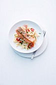 Salmon trout fillet on a bed of Spätzle (Swabian egg noodles) with tomatoes and horseradishes