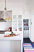 Island counter in modern, white kitchen