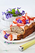 Breakfast bread with cream cheese icing, strawberries and violets