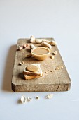 Toast topped with peanut butter and peanuts on a chopping board