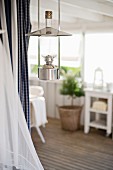 Retro oil lamp hanging from ceiling in rustic setting