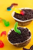 Two chocolate cupcakes decorated with jelly worms