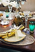 Festively set dinner table with Christmas crackers on plates