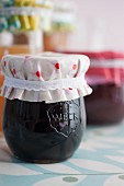 Jars of jam with covers upcycled from oilcloth remnants and ribbons