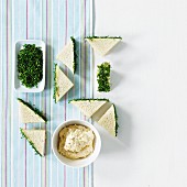 Mini tramezzini with tuna salad and a herb edge