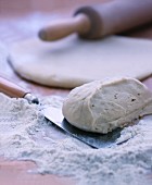 Yeast dough, flour and baking utensils