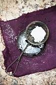 A sieve with icing sugar