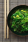 A bowl of seaweed salad with chopsticks (Japan)