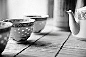 Chinese tea crockery on a bamboo mat (black and white image)