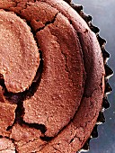 Freshly baked chocolate cake in a baking tin (detail)