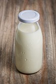 A milk bottle on a wooden surface