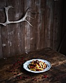 Marinated roasted root vegetables with pistachios and lingonberries