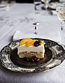 An orange cake slice with candied walnuts for New Year's Eve
