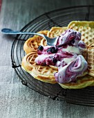 Sweet waffles with blueberry cream on a wire rack
