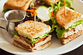 Vegan club sandwich with seitan, tomatoes and lettuce