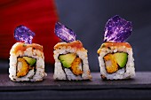 Drei Sushi mit Lachs, Avocado und violettem Kartoffelchip