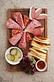 An appetiser platter with cured meats (seen from above)