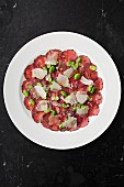 Cured meat with Parmesan and fava beans (seen from above)