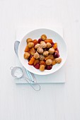 Sweet mini gnocci with raspberries and apricots