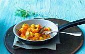 Prawns with curry and rosemary in a pan