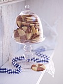 Black and white biscuits under a glass cloche