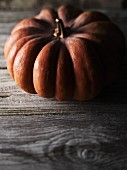 A pumpkin on a wooden surface