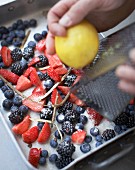 Summer berries with liquorice, lemon and cane sugar in a baking tin