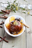 A baked onion with mushrooms and oranges