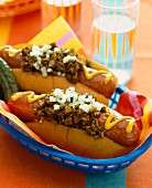 Chilli dogs with relish, onions and mustard
