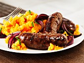 Sausages with mashed sweet potatoes and red onions
