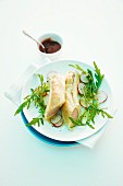 Sausages in puff pastry with rocket and radishes