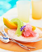 Cold melon dessert with edible flowers
