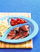 Beef steak with cherry tomatoes and pasta